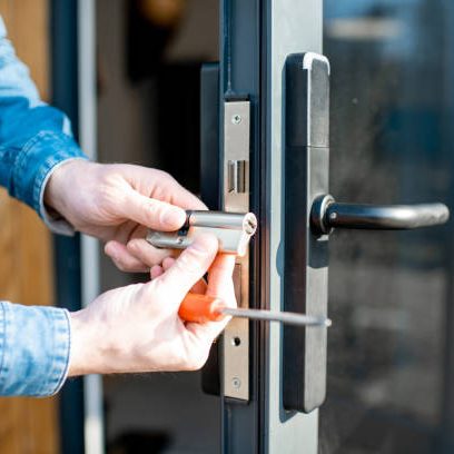 istockphoto-1138823660-612x612 Man changing core of a door lock of the entrance glass door, close-up view with no face